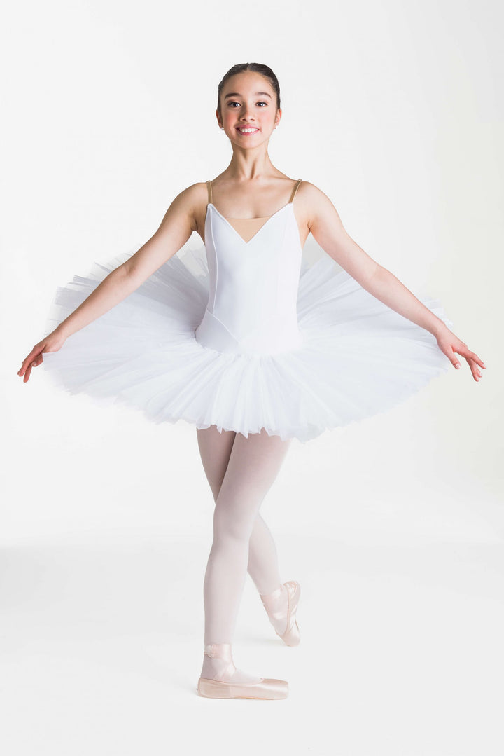 Ballerina in a white tutu posing against a white background