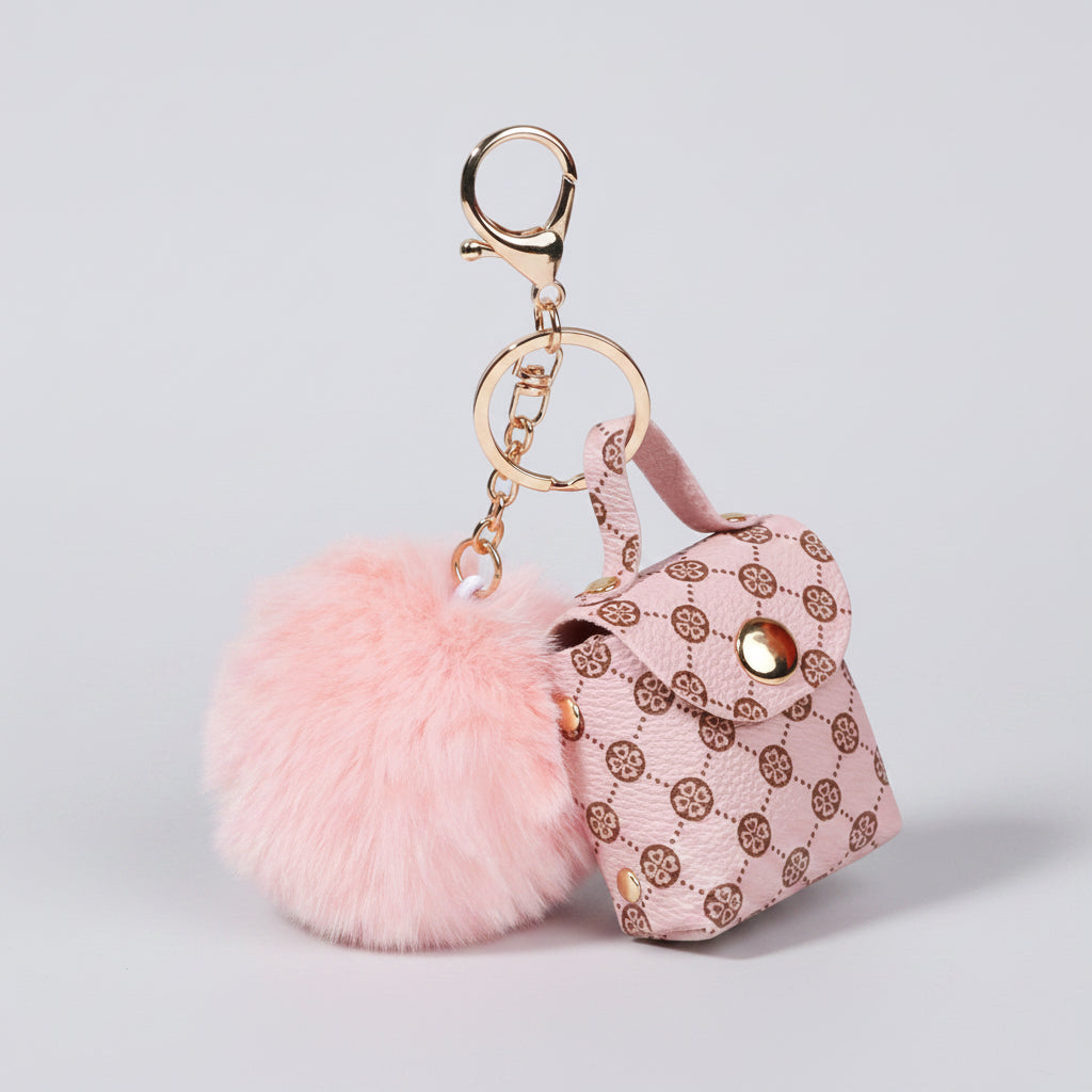 Pink keychain with a fluffy pom-pom and mini handbag